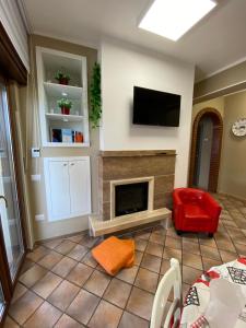 ein Wohnzimmer mit einem Kamin und einem Flachbild-TV in der Unterkunft B&B Ares Castel Baronia in Castel Baronia