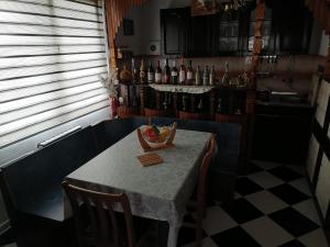a table with a bowl of fruit on it in a kitchen at Villa Shine Apartment 1 in Struga