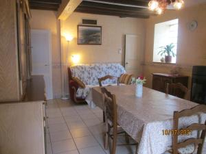a kitchen and dining room with a table and a couch at GITE A SAINT-REMY (21500) in Saint-Rémy