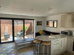 a kitchen with a counter top and a living room at No 6 Elizabeth Street in Congleton