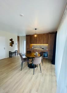 a dining room with a table and chairs and a kitchen at KoKo House Palanga in Palanga +14 photos