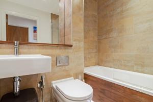 a bathroom with a toilet and a sink and a tub at 1-Bed Spacious Flat, North London, 15 Minutes to Central in New Southgate +19 photos