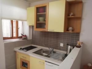 a kitchen with a sink and a counter top at Studio Old Centar in Cres