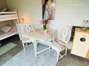 a room with a table and two chairs and a bed at Nösund Guestroom in Nösund