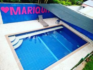 a swimming pool with a sign that reads marcin at La Orquidea in Mariquita