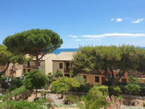 a view of a building with trees in the foreground at horizon sur mer 1137 in Saint Pierre La Mer