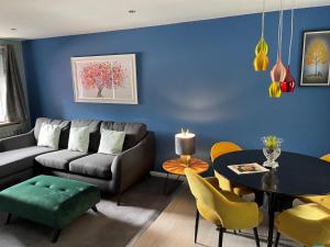 a living room with a couch and a table at Village Limits Bed and Breakfast Rooms in Woodhall Spa