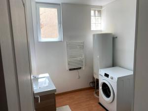 a laundry room with a washing machine and a window at Appartement Cosy à quelques minutes du Centre in Chalons en Champagne