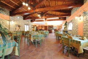 a restaurant with tables and chairs in a room at Al Giumani in Mammola
