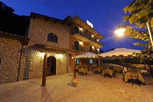 a building with tables and chairs at night at Al Giumani in Mammola