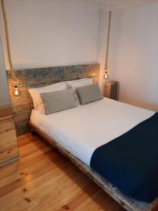 a bed with two pillows on it in a room at Lisbon Castle Apartment in Lisbon