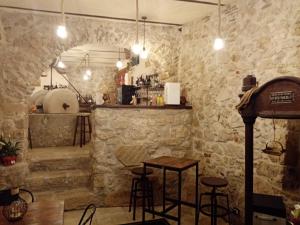 a bar with stone walls and stools at Emme House Bed&Breakfast in Pontecorvo