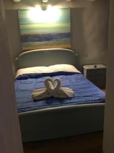 מיטה או מיטות בחדר ב-New Arcobaleno Ossegna