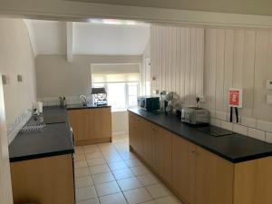 a large kitchen with a counter top in a room at The White Hart in Llantwit Major