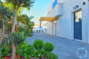 a walkway outside of a building with plants at Shani House Of Style SEATARA VILLA in Eilat