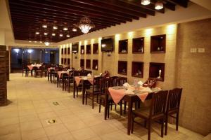 a dining room with tables and chairs in a restaurant at Oasis marsa alam in Marsa Alam City