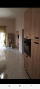 an empty room with a kitchen with a stove at Marina di Girgenti in Porto Empedocle
