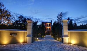 a driveway leading to a house at night with lights at Anthias Garden in Lefkada Town