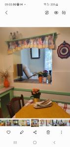 a dining room with a table and a window at Przytulny apartament-cosy and beautiful in Żywiec