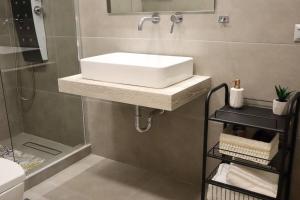 bagno con lavandino bianco e doccia di 360° View Suites Cos a Neapolis