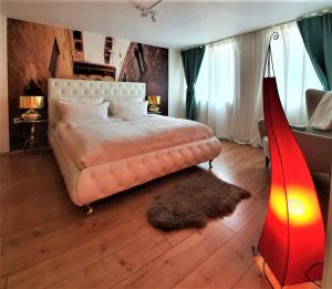a bedroom with a large bed and a red lamp at Design Apartment BarcelonaNights in Freiburg im Breisgau