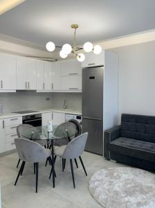 a kitchen with a table and chairs and a couch at The Nest Apartment in Zakynthos Town