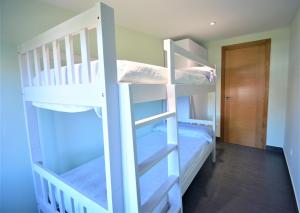 two bunk beds in a room with a hallway at Apartamento con terraza en Cambados in Cambados