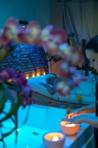 ローマにあるCorso Suite 107 Rooms Wellness & Spaの暖炉前のキャンドルと花のテーブル