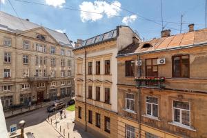 a group of buildings on a city street at Check-in Apartments in Lviv