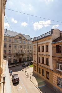 a car parked on a street in front of buildings at Check-in Apartments in Lviv