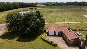 an aerial view of a small house in a field at The Coach House in Martin