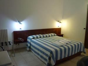 Un ou plusieurs lits dans un hébergement de l'établissement Hotel L'Ancora