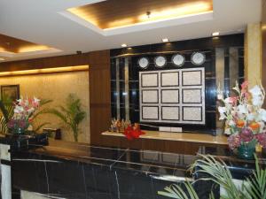 a lobby with a sign on a wall with flowers at Divine Paradise Tavisha in New Delhi