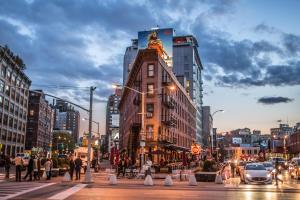 a building with a statue on top of it on a city street at JGSTAY - Koreatown in New York