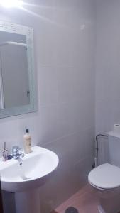 Baño blanco con lavabo y aseo en Apartamento Loft III Select Real Caldas de Reis, en Caldas de Reis