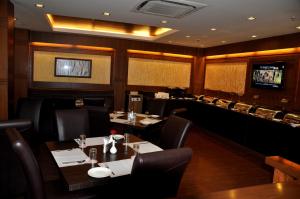 a dining room with tables and chairs in a restaurant at Divine Paradise Tavisha in New Delhi