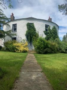 a white building with a dome on top of it at Fiddleback Farm in Wigton