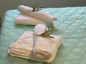 three towels sitting on top of a bed at "Stalia" beach house in Vári