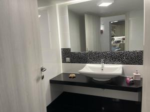 a bathroom with a sink and a mirror at "Stalia" beach house in Vári +36 photos