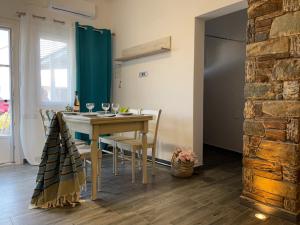 a kitchen and dining room with a table and chairs at "Stalia" beach house in Vári