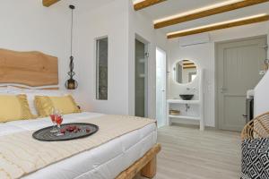 a bedroom with a bed with a tray of fruit on it at Marine Dream in Plaka