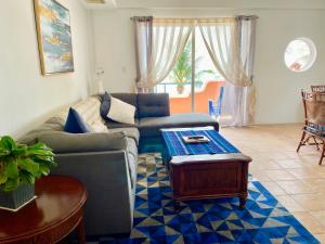 a living room with a couch and a table at Seaside Villas in Caye Caulker