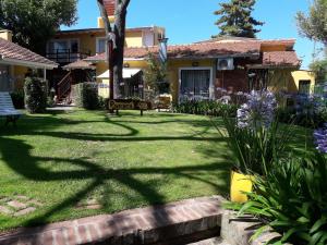 a yard with a sign in front of a house at pucará in Villa Gesell