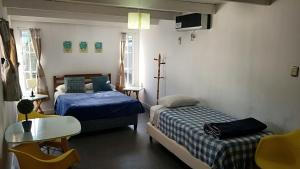 Säng eller sängar i ett rum på Squania Suite Container & Monoambientes