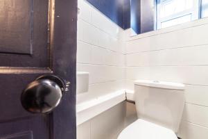 a bathroom with a toilet and a door with a window at Realm choice estates in Catford