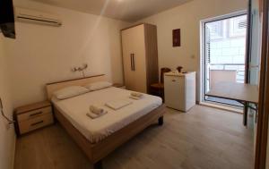 a bedroom with a bed with two towels on it at Apartments Dragica in Milna