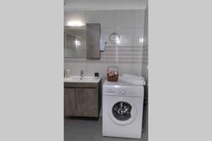 a kitchen with a washing machine and a sink at Thea family apartments 3 in Yenion