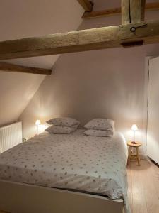 a bedroom with a bed with two pillows on it at MaMoMa in Sint-Martens-Latem