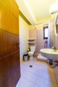 a bathroom with a toilet and a sink at Harmony House in Platanias