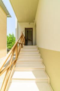 a staircase leading up to a hallway with a door at Harmony House in Platanias